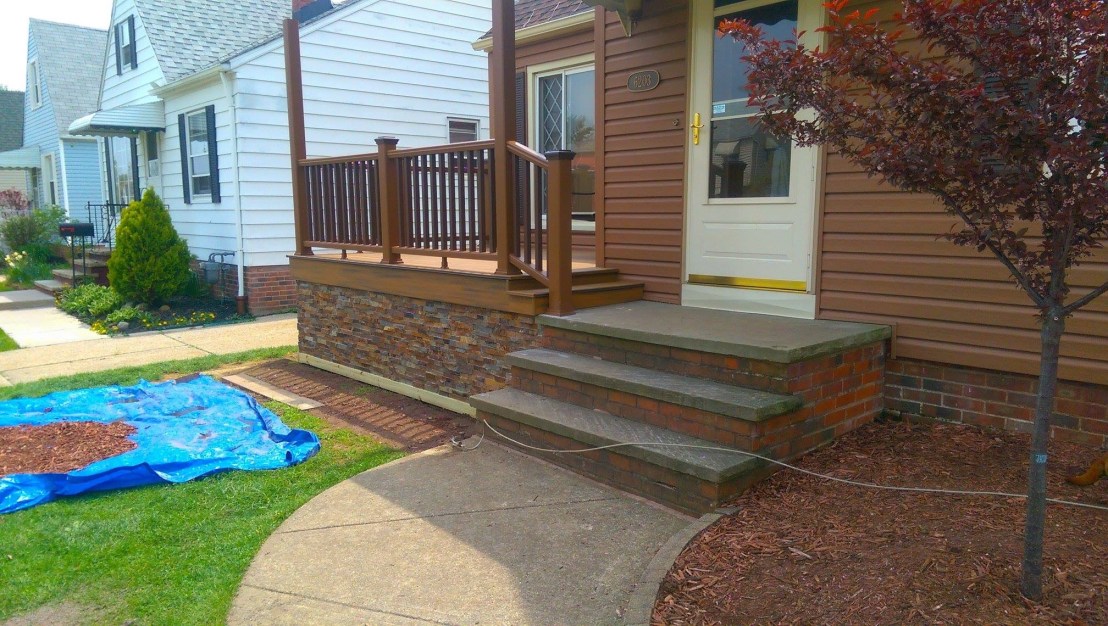 Composite Deck Porch with composite rails and stone trim